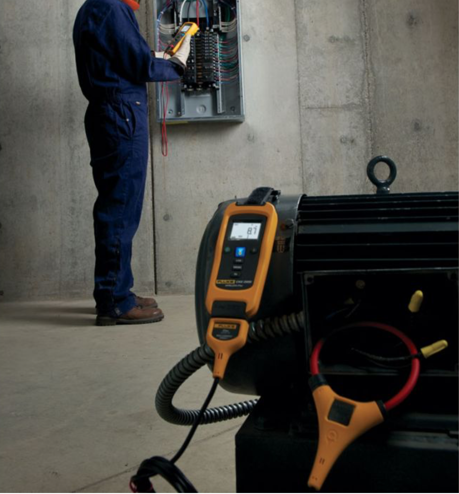 Technician conducting electrical load testing on a commercial electrical system.