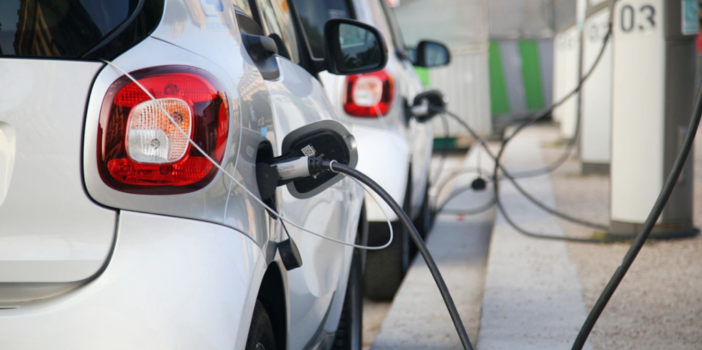 Technicians installing an electric vehicle charging station, meeting the growing demand for EV infrastructure.