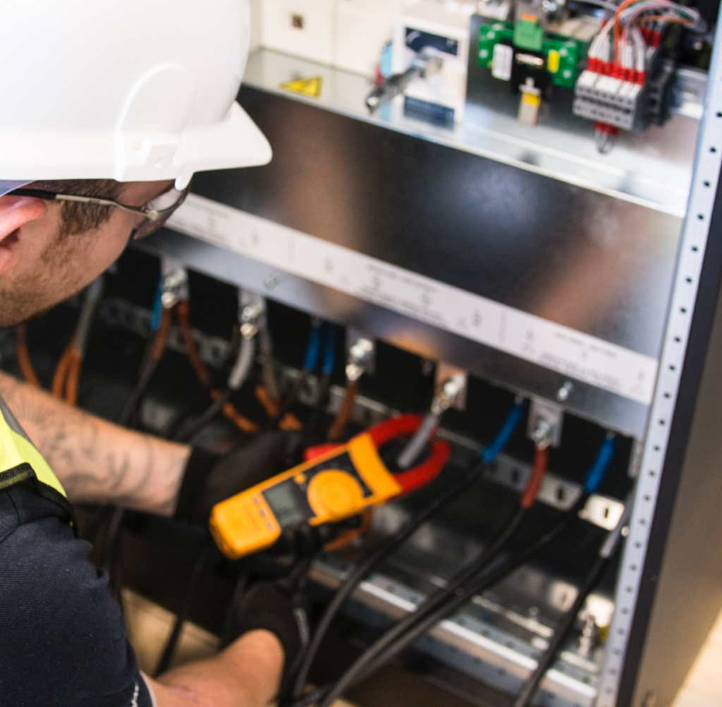 Technician conducting load testing on electrical equipment.