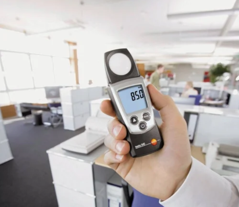 Technician conducting lux testing on emergency lighting system.