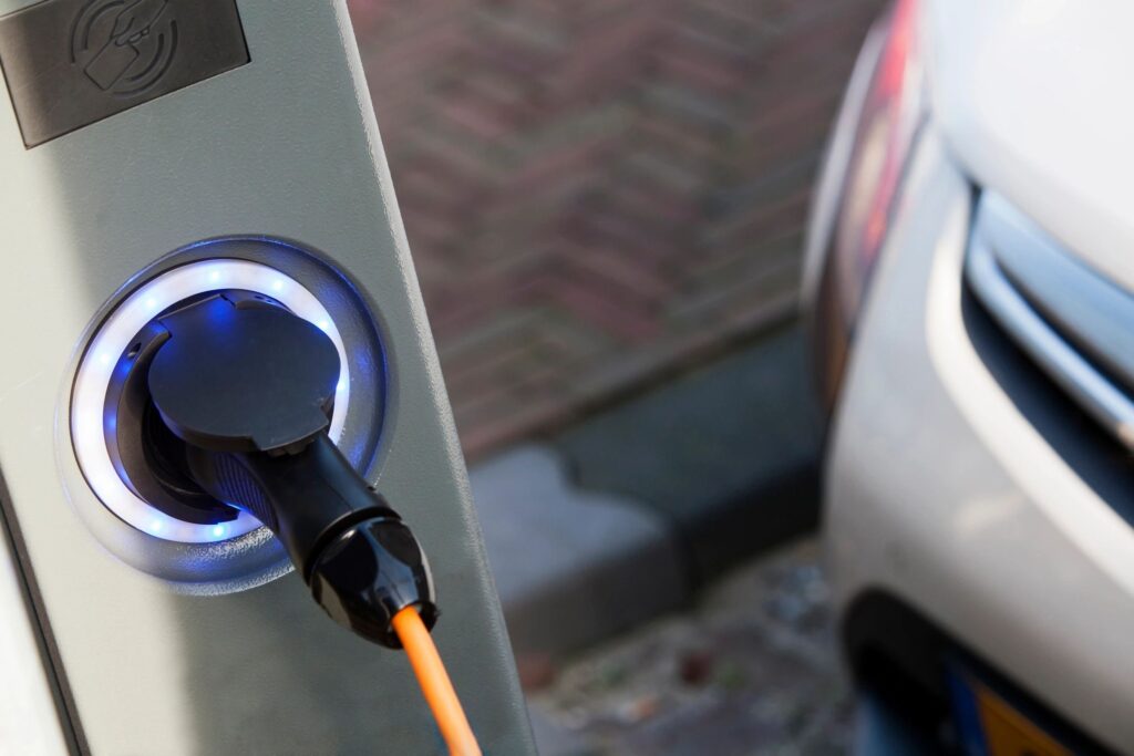 Accredited Tesla installers setting up an electric vehicle charging station.