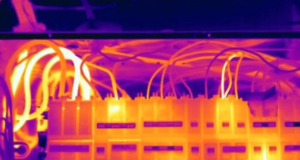 Thermal imaging camera detecting heat patterns in electrical components.