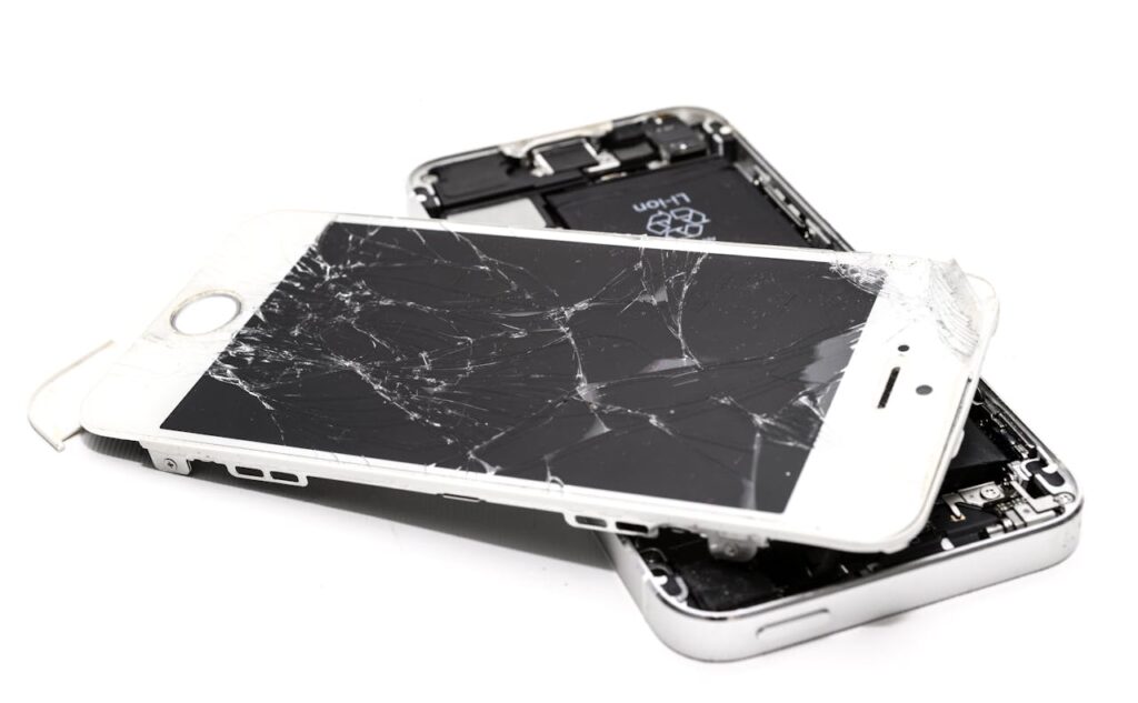  Close-up of a wrecked iPhone ready for recycling, illustrating the importance of responsible disposal to prevent environmental contamination